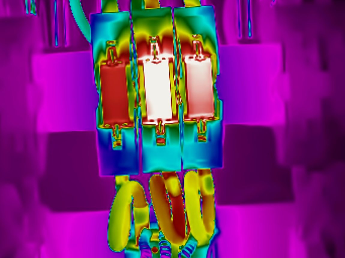 Infrared image of the same fuse switches. The middle way is glowing white hot while the identical ways either side of it stay cool.